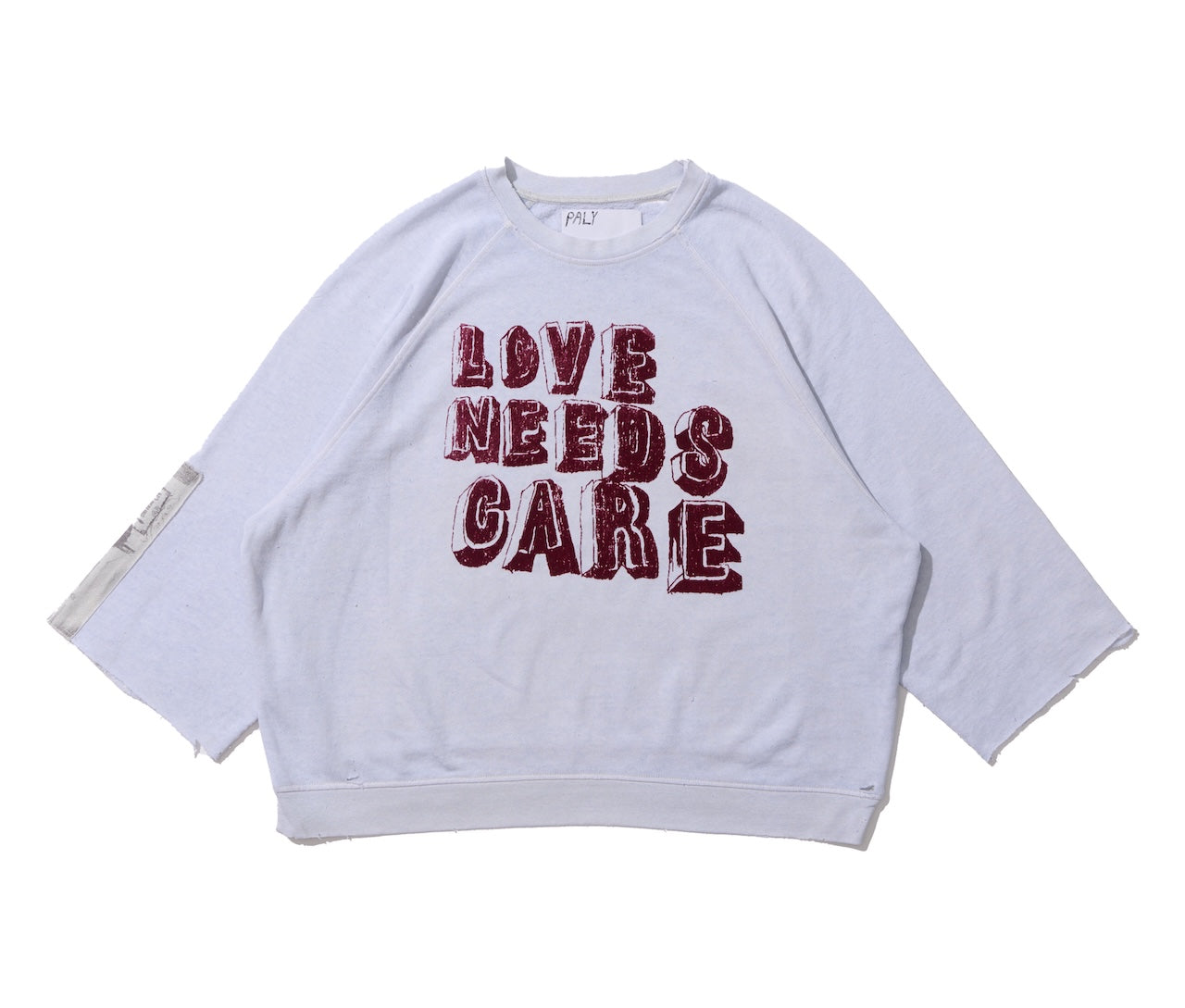 LOVE NEEDS CARE CREWNECK