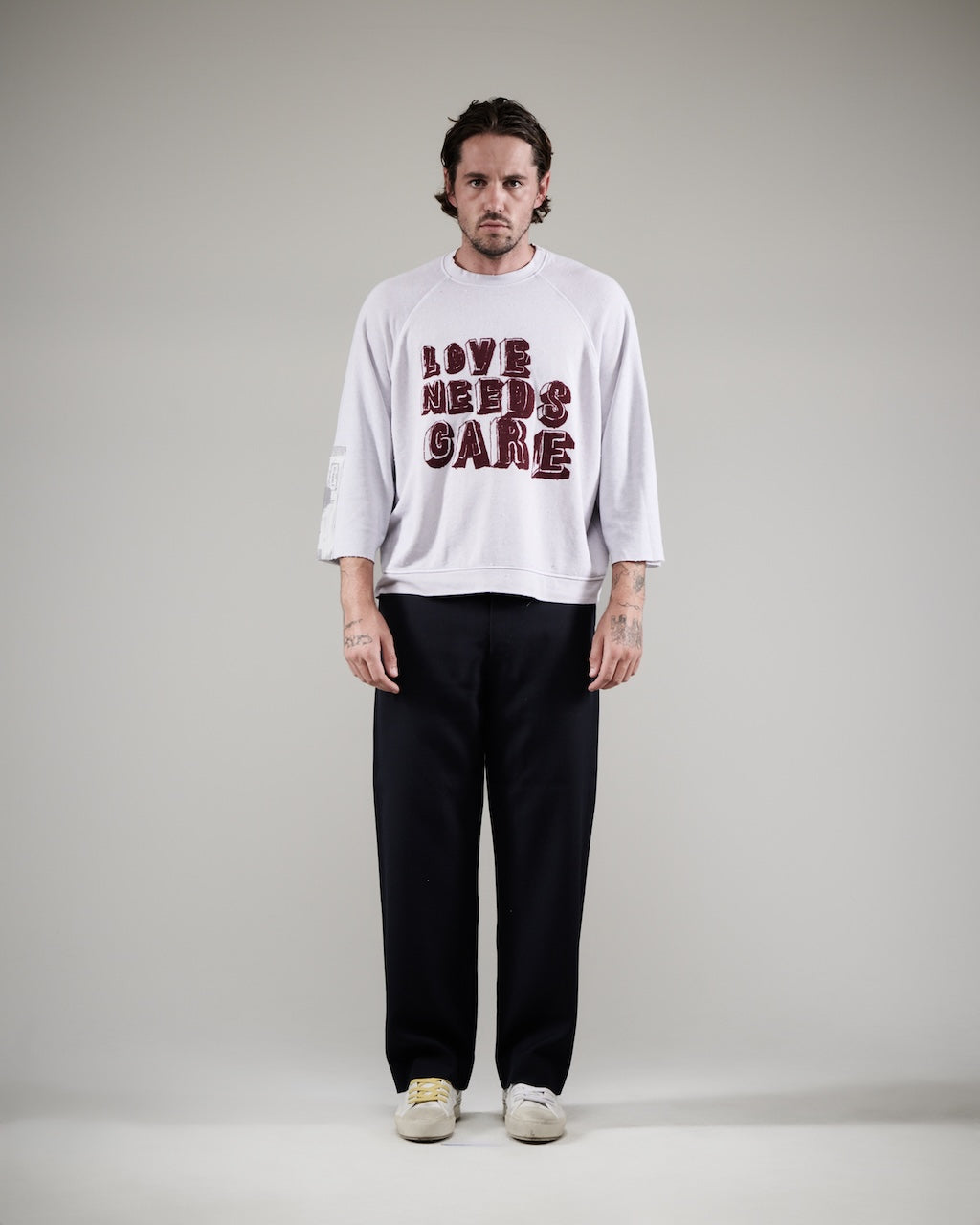 LOVE NEEDS CARE CREWNECK